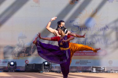 Faridabad, Haryana, Hindistan - 17 Şubat 2024: Güney Hintli erkek ve kadın sanatçı Surajkund sanatları fuarında klasik dans kuchipudi performansı sergiliyorlar.