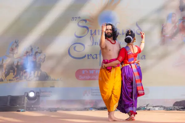 stock image Faridabad, Haryana, India - February 17 2024: Portrait of male and female south indian artist performing classical dance kuchipudi on stage at surajkund craft fair.