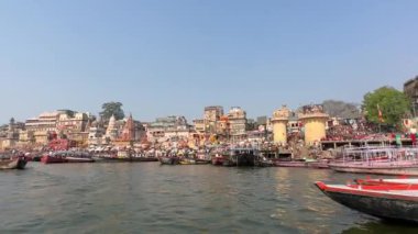 Varanasi, Uttar Pradesh, Hindistan - 22 Mart 2024: Antik binanın mimari görünümü ve kutsal nehir çetelerinin kıyısındaki tapınaklar ahşap bottan.