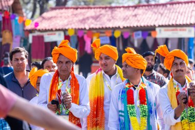 Faridabad, Haryana, India - February 17 2024: Portrait of male folk artist of haryana playing musical instrument during surajkund craft fair to entertain tourists.