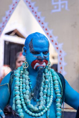 Faridabad, Haryana, India - February 17 2024: Portrait of an young male artist with painted face to play the character of jinn of aladdin series to entertain tourists.