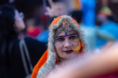 Faridabad, Haryana, India - February 17 2024: Portrait of beautiful young woman in ethnic dress and jewellery participating in cultural folk activities at surajkund craft fair.