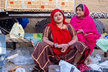 Faridabad, Haryana, India - February 17 2024: Portrait of an woman selling iron and metal products at the surajkund crafts fair.