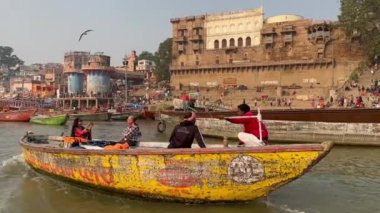 Varanasi, Uttar Pradesh, Hindistan - 21 Kasım 2022: Antik bina ve tapınakların mimari görüşü üzerine video Dashashwamedh ghat yakındaki kutsal nehir çeteleri ahşap bottan.