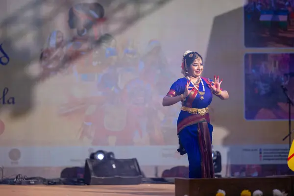 stock image Faridabad, Haryana, India - February 17 2024: Female south indian artist performing classical dance kuchipudi at surajkund craft fair in traditional silk saree and jewelry. 