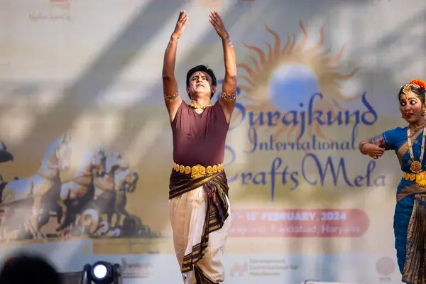 stock image Faridabad, Haryana, India - February 17 2024: Group of male and female south indian artists performing classical dance kuchipudi on stage during surajkund crafts fair in ethnic costumes. 