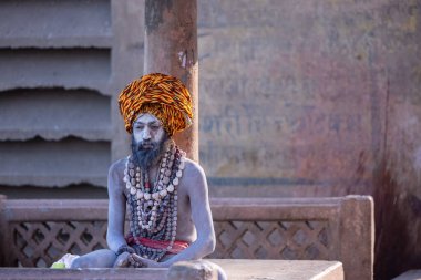 Varanasi, Uttar Pradesh, Hindistan - 05 Mart 2023: Varanasi 'deki çetelerin yakınındaki ghatlarda geleneksel giysiler giyen insanlar.
