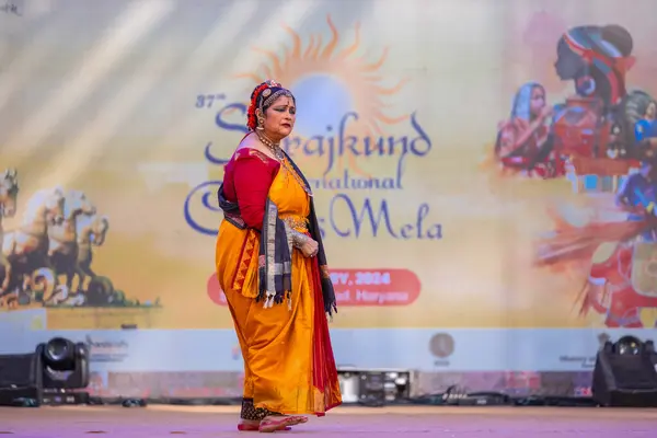 stock image Faridabad, Haryana, India - February 17, 2024: Portrait of female south indian artist performing classical dance kuchipudi at surajkund craft fair in traditional silk saree and jewelry.