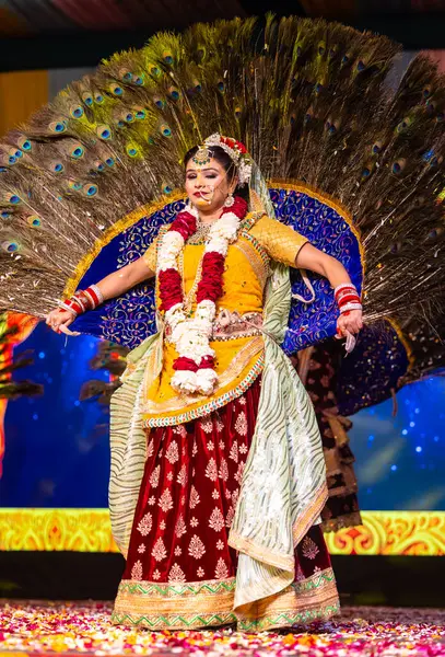 stock image Ghaziabad, Uttar Pradesh, India - March 17, 2024: Portrait of young female artist performing as goddess radha during holi milan festival in colourful ethnic clothes and jewellery. 