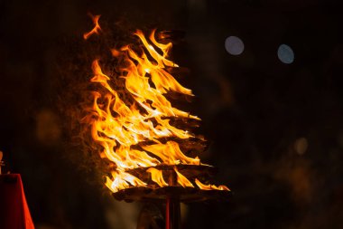 Ganga aarti, Fire flame at night with dark background during the ganga aarti rituals at river bank of Varanasi. clipart