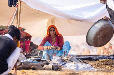 Puşkar, Rajasthan, Hindistan - 24 Kasım 2023: Pushkar Deve Fuarı sırasında, geleneksel renkli elbiseli Hintli kadının portresi.