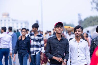 Ghaziabad, Uttar Pradesh, India - November 19 2023: Group of Indian people walking towards the bank of river to perform the rituals of chhath puja in ethnic colourful clothes with their family. clipart