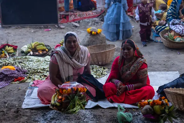 stock image Ghaziabad, Uttar Pradesh, India - November 19, 2023: Chhath Puja, Group of indian women sitting on ground to perform the rituals of Chhath puja in traditional ethnic clothes.