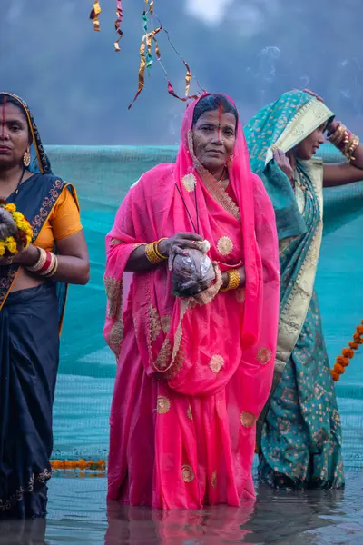 stock image Ghaziabad, Uttar Pradesh, India - November 19 2023: Chhath Puja, Group of indian hindu women devotee performing rituals of chhath puja with standing in river to worship lord sun during sunset.