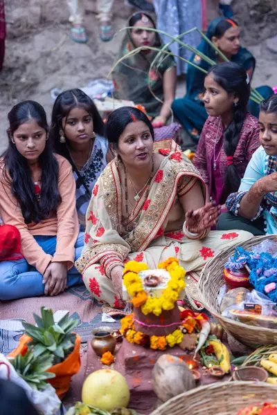 stock image Ghaziabad, Uttar Pradesh, India - November 19, 2023: Chhath Puja, Group of indian women sitting on ground to perform the rituals of Chhath puja in traditional ethnic clothes.