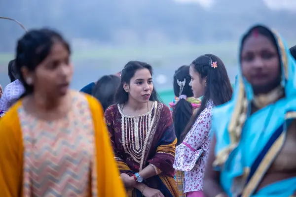 stock image Ghaziabad, Uttar Pradesh, India - November 19 2023: Chhath Puja, Group of indian people standing on ground to perform the rituals of chhath puja in traditional ethnic clothes.