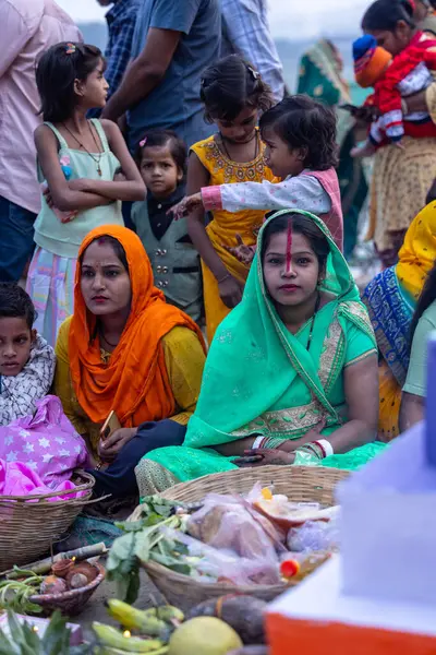 stock image Ghaziabad, Uttar Pradesh, India - November 19, 2023: Chhath Puja, Group of indian women sitting on ground to perform the rituals of Chhath puja in traditional ethnic clothes.