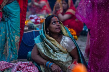 Chhath Puja, Chhath puja in traditional ethnic clothes near river bank clipart