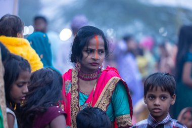 Chhath Puja, Chhath puja in traditional ethnic clothes near river bank clipart