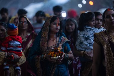 Chhath Puja, Chhath puja in traditional ethnic clothes near river bank clipart