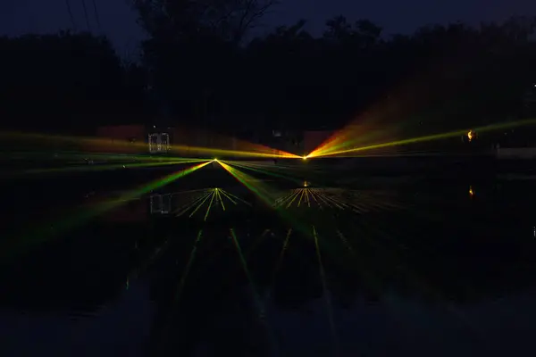 stock image Ghaziabad, Uttar Pradesh, India - November 19, 2023: Laser light show in the evening near Hindon river during Chhath Puja celebration.