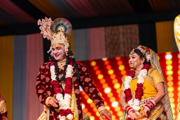 stock image Ghaziabad, Uttar Pradesh, India - March 17th, 2024: Portrait of a young artists playing phoolo ki holi as lord Krishna friend on stage during Holi festival in colorful ethnic clothes.