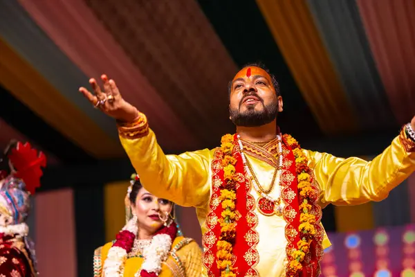 stock image Ghaziabad, Uttar Pradesh, India - March 17th, 2024: Portrait of a young artists playing phoolo ki holi as lord Krishna friend on stage during Holi festival in colorful ethnic clothes.