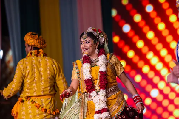 stock image Ghaziabad, Uttar Pradesh, India - March 17th, 2024: Portrait of a young artists playing phoolo ki holi as lord Krishna friend on stage during Holi festival in colorful ethnic clothes.