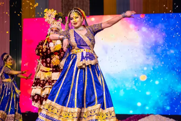 stock image Ghaziabad, Uttar Pradesh, India - March 17th, 2024: Portrait of a young artists playing phoolo ki holi as lord Krishna friend on stage during Holi festival in colorful ethnic clothes.