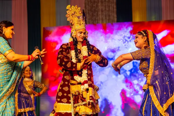 stock image Ghaziabad, Uttar Pradesh, India - March 17th, 2024: Portrait of a young artists playing phoolo ki holi as lord Krishna friend on stage during Holi festival in colorful ethnic clothes.