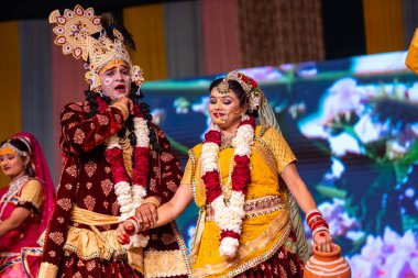 Gaziabad, Uttar Pradesh, Hindistan - 17 Mart 2024: Holi Festivali sırasında renkli etnik giysiler içinde sahnede phoolo ki holi 'yi oynayan genç bir sanatçının portresi.