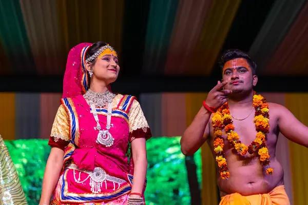 stock image Ghaziabad, Uttar Pradesh, India - March 17th, 2024: Portrait of a young artists playing phoolo ki holi as lord Krishna friend on stage during Holi festival in colorful ethnic clothes.