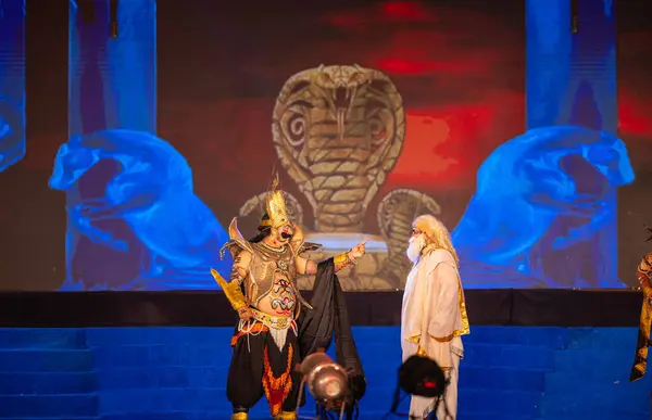 stock image Ghaziabad, Uttar Pradesh, India - October 24 2023: Portrait of a male artist playing character devil king Ravana with other character of an old man of Ramayana in Ramlila during the Dussehra festival. 