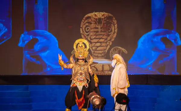 stock image Ghaziabad, Uttar Pradesh, India - October 24 2023: Portrait of a male artist playing character devil king Ravana with other character of an old man of Ramayana in Ramlila during the Dussehra festival. 