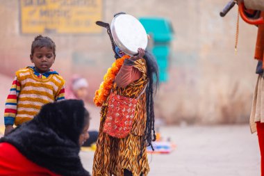 Varanasi, Uttar Pradesh, Hindistan - 18 Ocak 2024: Varanasi 'deki çetelerin yakınındaki ghat' larda yaşayan insanlar. Sadhu, Kaşhi 'de Ganga yakınlarında meditasyon yapıyor..