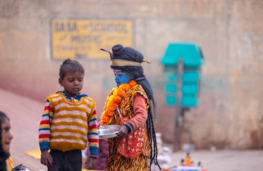 Varanasi, Uttar Pradesh, Hindistan - 18 Ocak 2024: Varanasi 'deki çetelerin yakınındaki ghat' larda yaşayan insanlar. Sadhu, Kaşhi 'de Ganga yakınlarında meditasyon yapıyor..