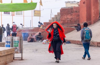 Varanasi, Uttar Pradesh, Hindistan - 18 Ocak 2024: Varanasi 'deki çetelerin yakınında. Sadhu, Kaşhi 'de Ganga yakınlarında meditasyon yapıyor..