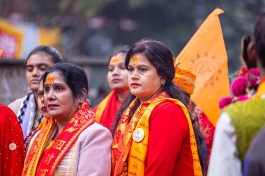 Varanasi, Uttar Pradesh, Hindistan - 18 Ocak 2024: Varanasi 'deki gnaga nehri ghatlarının üzerinde duran geleneksel sarili Hintli bir kadının portresi.