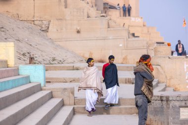 Varanasi, Uttar Pradesh, Hindistan - 19 Ocak 2024: Varanasi 'deki kutsal nehir gangası ghatlarındaki insanlar.
