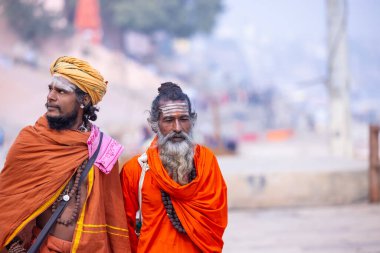 Varanasi, Uttar Pradesh, India - January 19 2024: People at ghats of holy river ganga in varanasi during winter morning. clipart