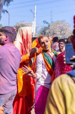 İnsanlar geleneksel ve törensel renkli Lathmar Holi 'yi Radharani tapınağında dans ve renkli yüzlerle kutluyorlar.