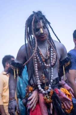 Varanasi, Uttar Pradesh, Hindistan - Mart 03 2023: Masan Holi, Harishchandra Ghat 'taki masaan Holi kutlamaları sırasında Lord Shiva gibi giyinmiş kül yüzlü bir erkek dindar portresi.
