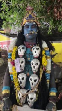 Thiruchendur, Tamilnadu, Hindistan - Ekim 2024: 4k clip, Hintli dindar portresi boyalı yüz ve Hindu tanrısı gibi giyinmiş geceleri kulasai dasara tarikat festivalini gerçekleştirmek için.