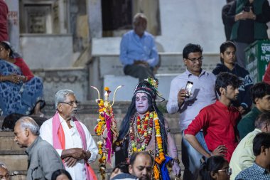 Pushkar, Rajasthan, India - November 25 2023: priest performing evening maha aarti (prayer) of holy lake of pushkar called sarovar at pushkar as hindu rituals. clipart