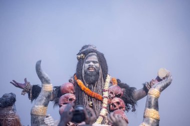 Varanasi, Uttar Pradesh, India - March 03 2023: Masan Holi, Portrait of an male devotee with painted face with dry ash dressed as lord shiva during the celebration of masan holi at harishchandra ghat. clipart