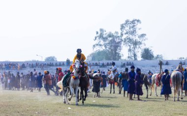 Anandpur Sahib, Punjab, Hindistan - 19 Mart 2022: Hola Mohalla festivali sırasında Hola Mohalla kutlamaları sırasında bir grup sikh insan (Nihang Sardar) Holi festivali sırasında Anandpur Sahib sokaklarında. Seçili odak.