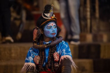 Varanasi, Uttar Pradesh, India - January 20 2024: Ganga aarti, river ganga early morning aarti at assi ghat in traditional dress with rituals. clipart