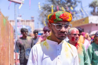 people from Nandgoan visits Barsana to play colorful Holi with the Women of Barsana as ritual of Lathmar holi every year clipart