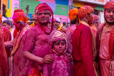 people from Nandgoan visits Barsana to play colorful Holi with the Women of Barsana as ritual of Lathmar holi every year clipart