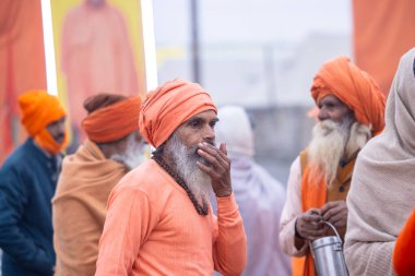 Prayagraj, Uttar Pradesh, India - January 13, 2025: Mahakumbh, Portrait of holy male sadhu baba participating in maha kumbh mela at prayagraj to take holy dip in river ganga at sangam and worship. clipart